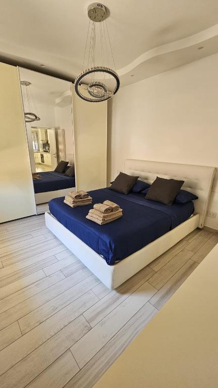 a bedroom with a large bed and a large mirror at Appartamento Lindo e Dora - A due passi dal mare in San Benedetto del Tronto