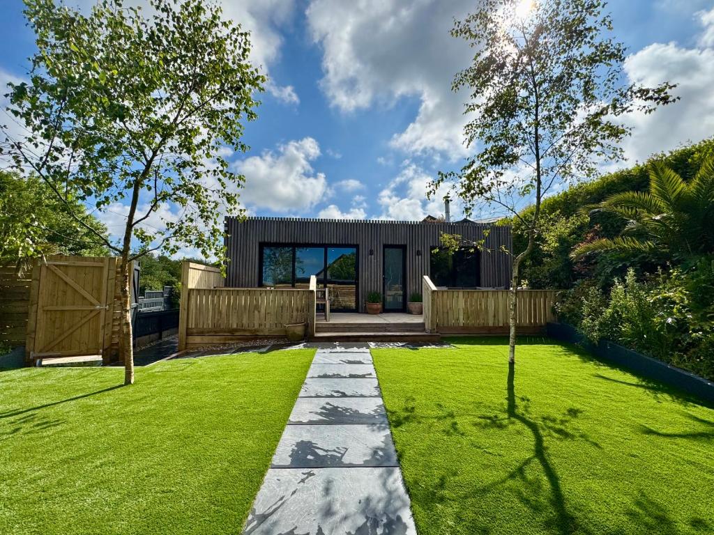 a garden with a house with a lawn at Uno Moor Side - 4 Bed, 2 Bath, Garden, sleeps 8 - Parking in Carbis Bay