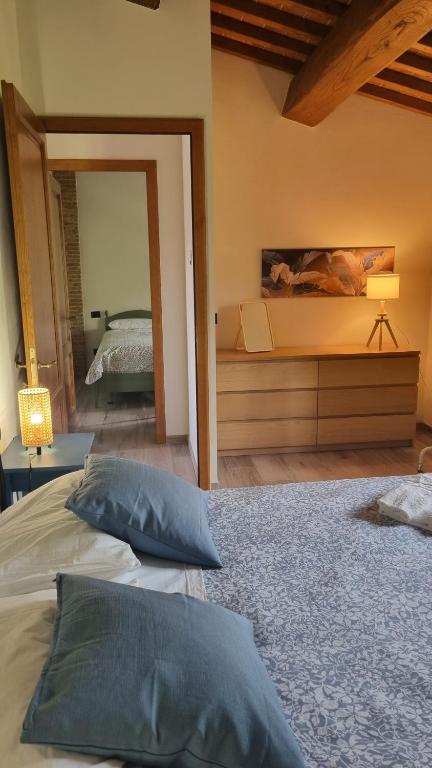 a bedroom with a large bed and a mirror at Casa Ottavina in Borgo a Buggiano