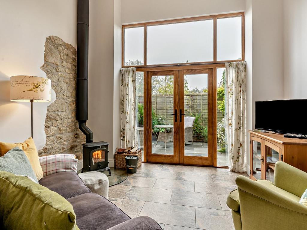 a living room with a couch and a fireplace at 1 bed property in Shaftesbury 46774 in Bourton