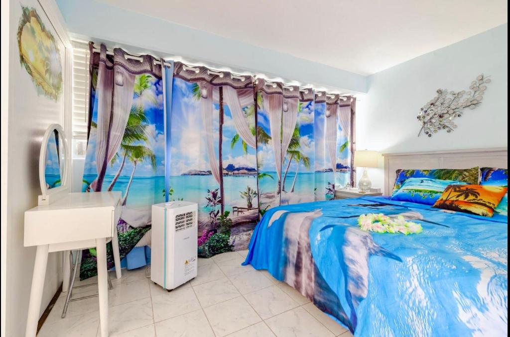 a bedroom with a bed and a sink and a mirror at WAIKIKI 2 BEDROOMS, 1 BATH, FREE PARKING, SLEEP 6 in Honolulu