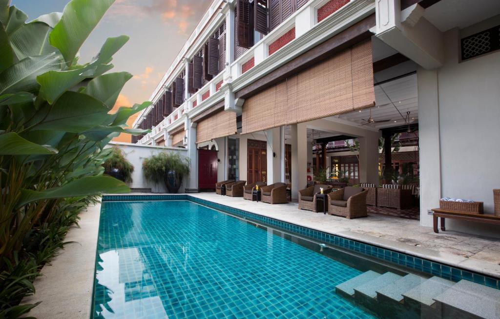 a swimming pool in front of a building with a resort at Seven Terraces in George Town
