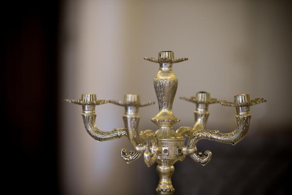 a brass chandelier with three lights on it at Jawi Peranakan Mansion in George Town