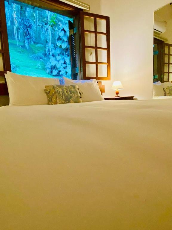 Uma cama ou camas num quarto em Tília Pousada de Charme