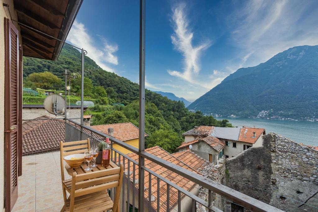 a balcony with a view of the water and mountains at Villetta Panebianco Home in Castagna 11 by Rent All Como in Nesso