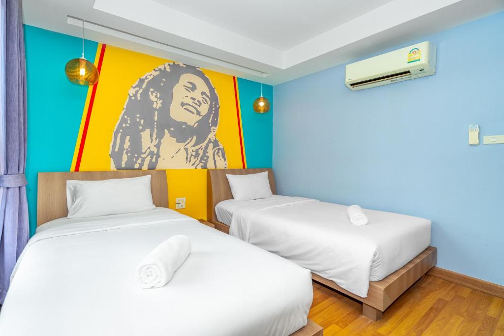 Postel nebo postele na pokoji v ubytování Anchan Boutique Hotel