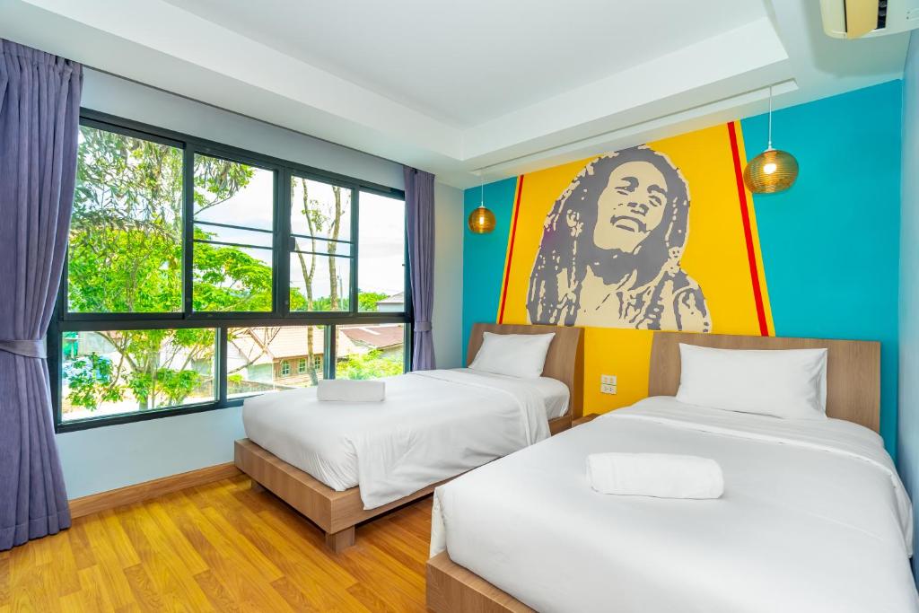 Postel nebo postele na pokoji v ubytování Anchan Boutique Hotel