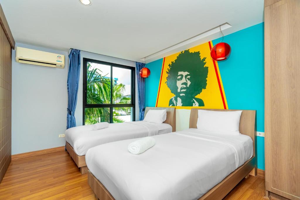 Postel nebo postele na pokoji v ubytování Anchan Boutique Hotel