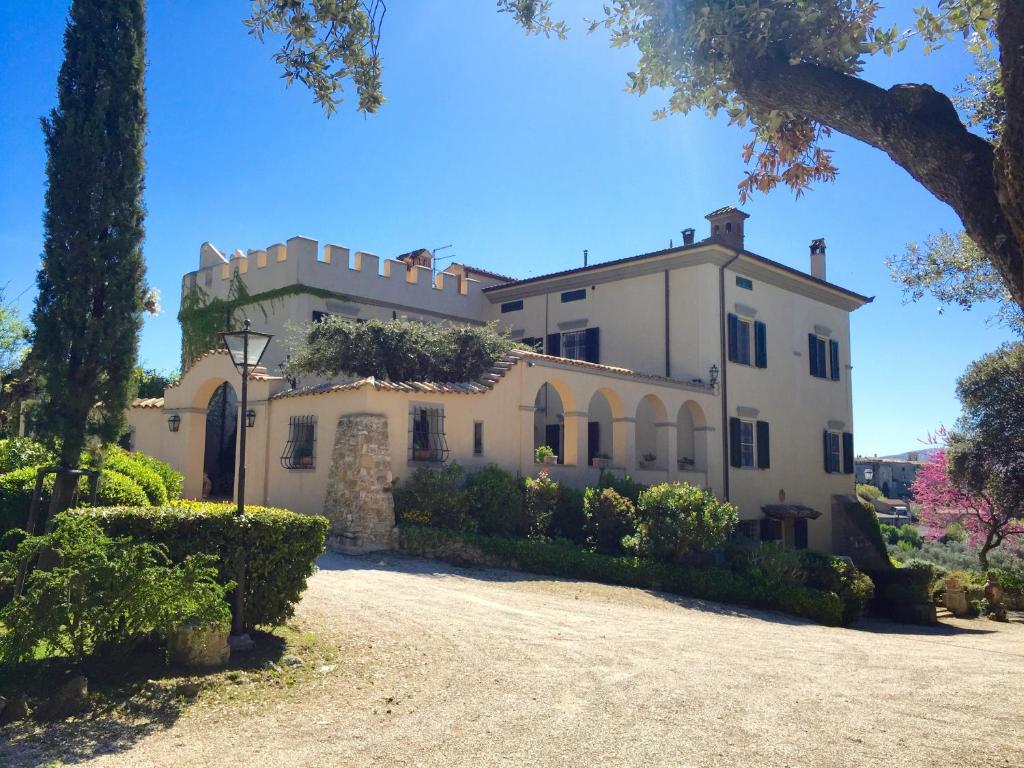 a large white house with trees and bushes at La Ghirlanda Wine Resort in Saragano