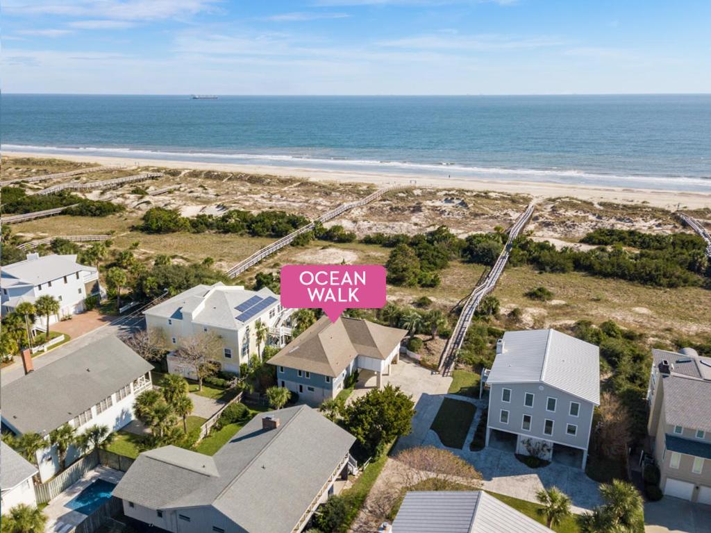 an aerial view of a beach with houses and a pink sign at Ocean Walk in Tybee Island