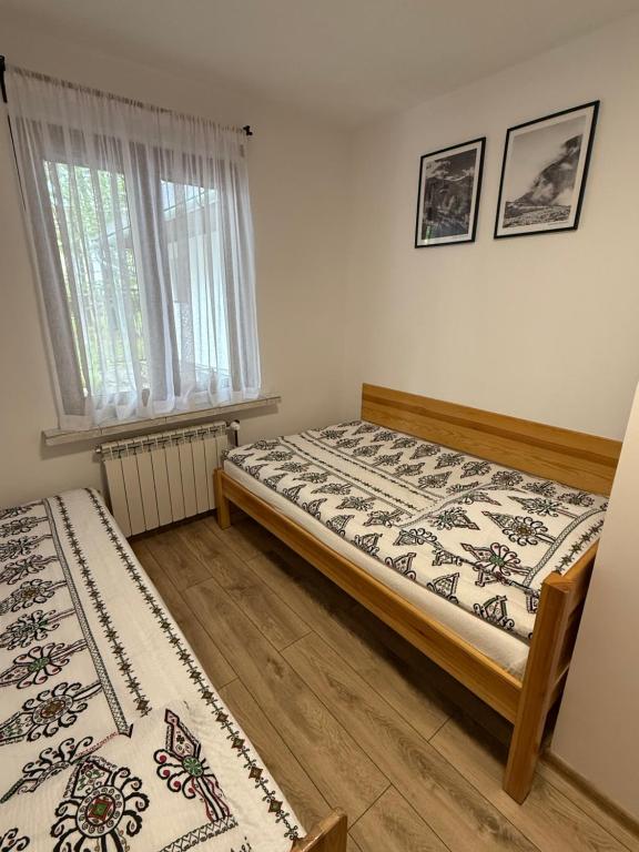 Posteľ alebo postele v izbe v ubytovaní Pokoje gościnne Kozica