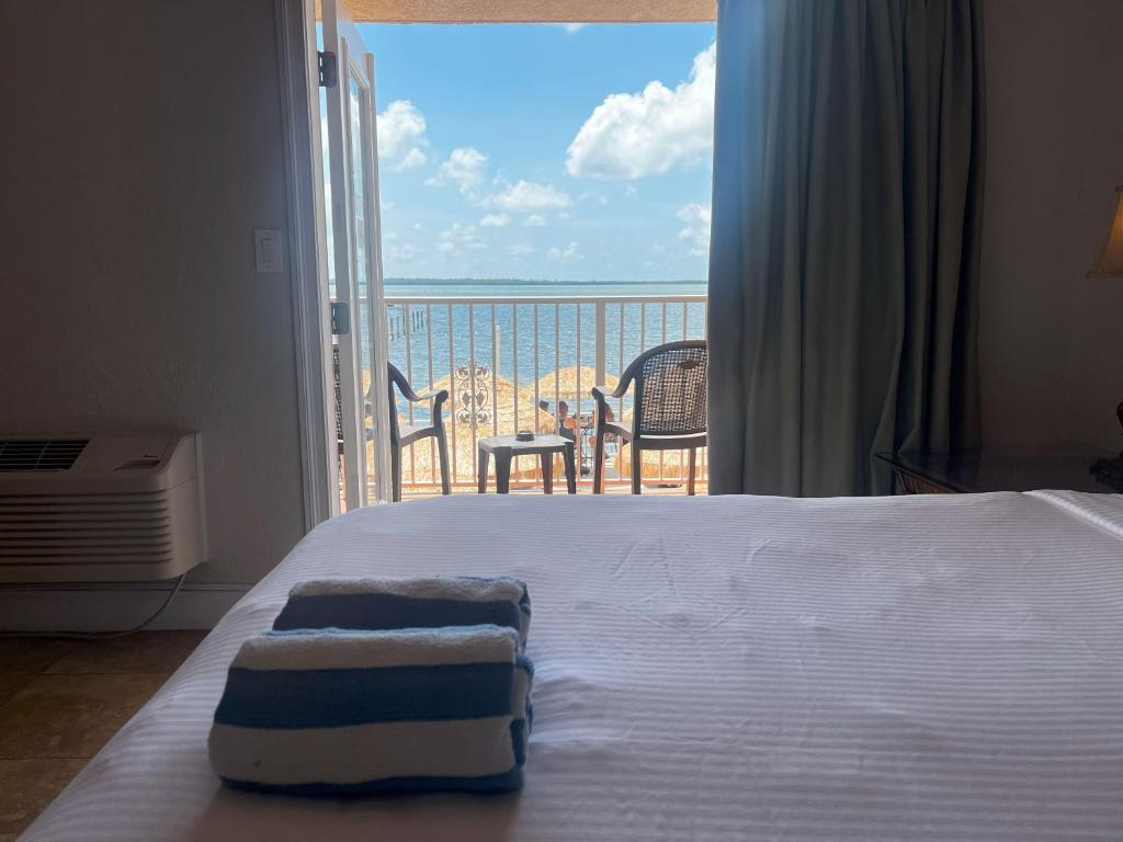 a bedroom with a bed with a view of the ocean at Beso Del Sol Resort in Dunedin