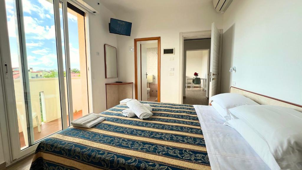 Postel nebo postele na pokoji v ubytování Hotel Patrizia - B&B e Appartamenti