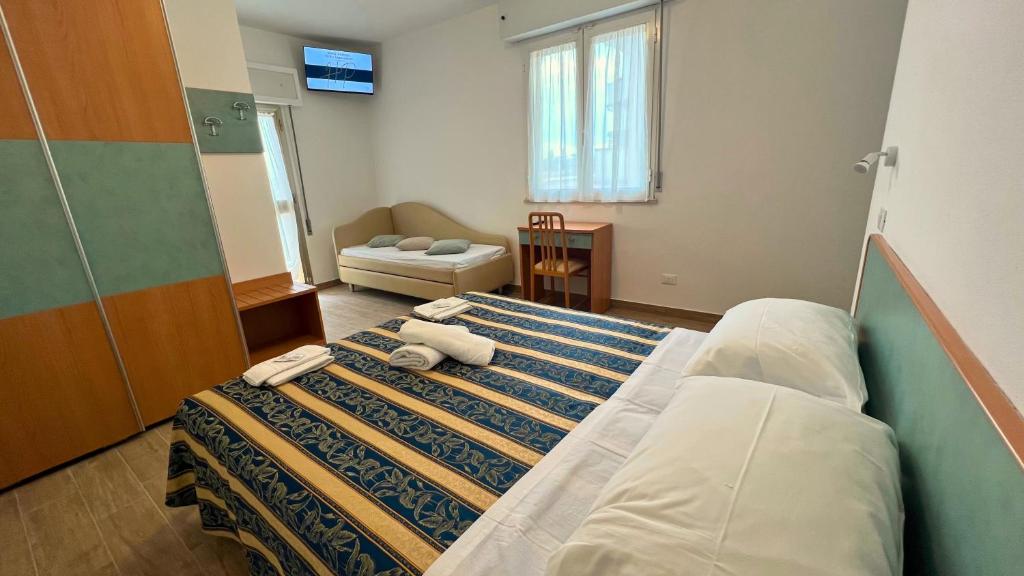 Postel nebo postele na pokoji v ubytování Hotel Patrizia - B&B e Appartamenti