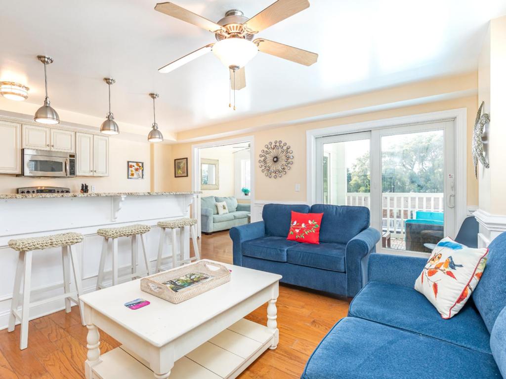 a living room with two blue couches and a table at Captains Watch 11 in Tybee Island