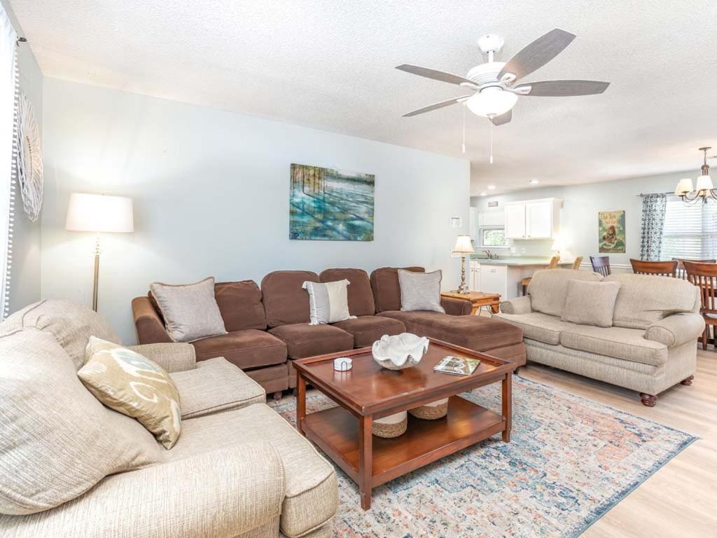 a living room with a couch and a table at Beach Song in Tybee Island