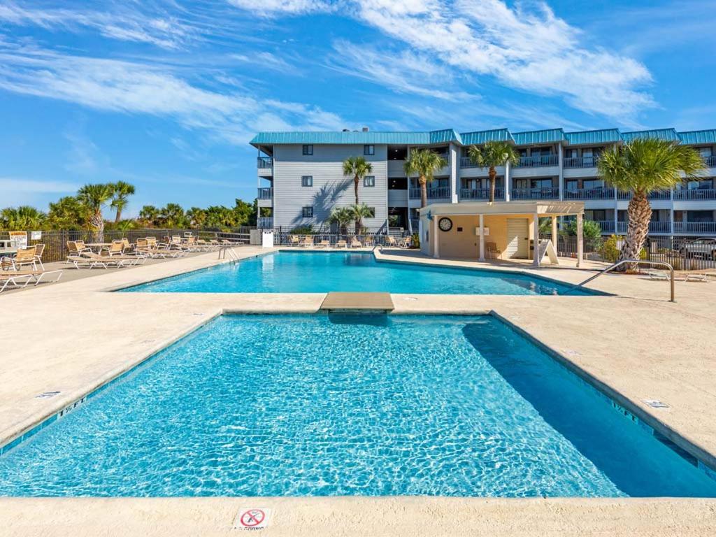 a swimming pool in front of a building at Beach Racquet A301 in Tybee Island