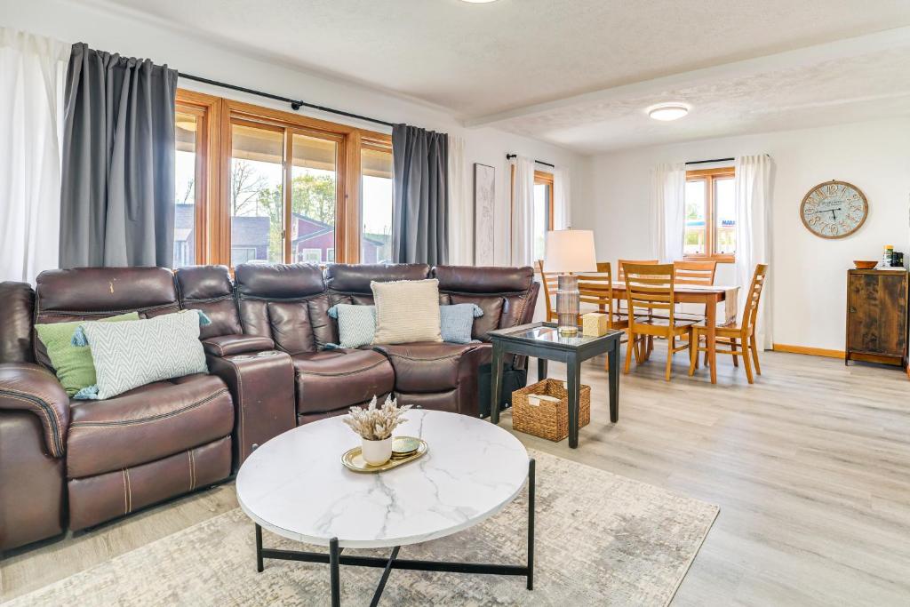 a living room with a leather couch and a table at 2 Living Areas! Cedar Home 11 Mi to Mt Holiday Ski in Cedar