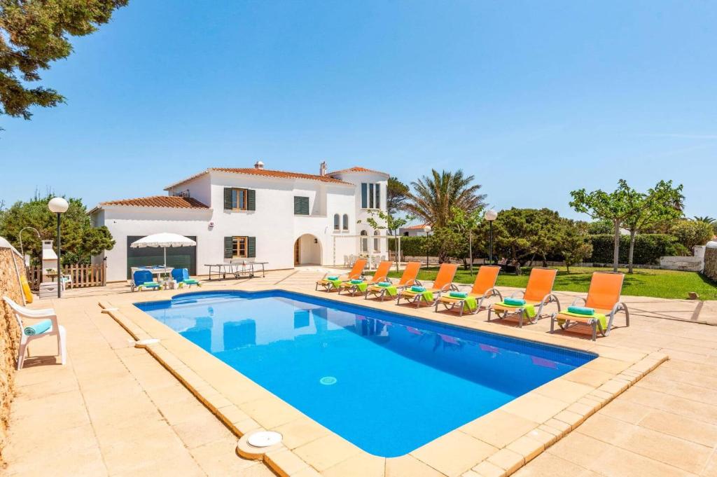 una villa con piscina frente a una casa en Villa Xabec by Villa Plus, en Cala en Blanes