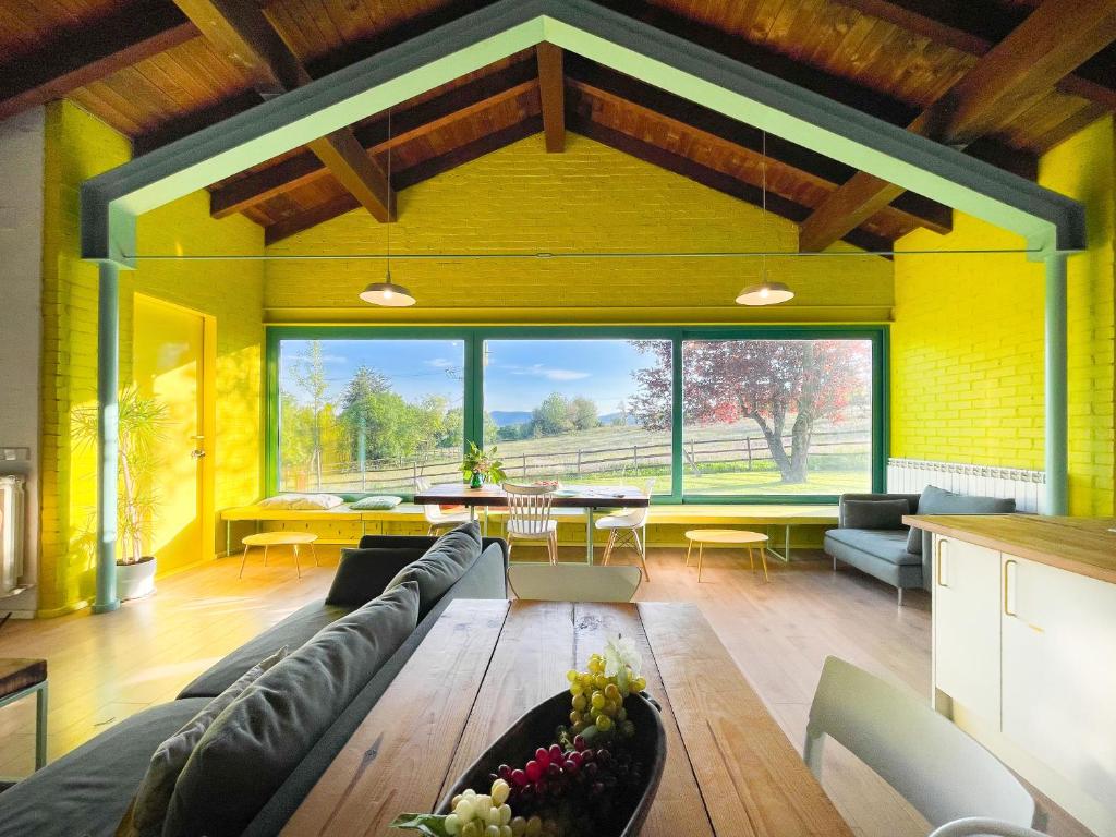a living room with a couch and a table at La Casa Amarilla de Cercedilla in Cercedilla