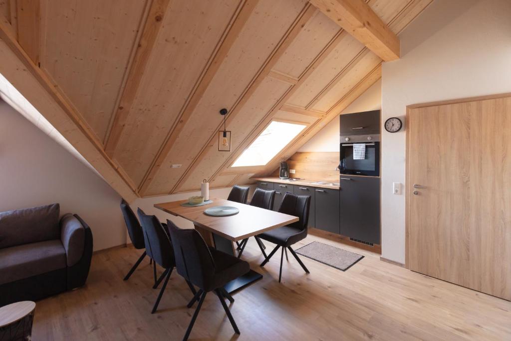 eine Küche und ein Esszimmer mit Tisch und Stühlen in der Unterkunft Lewe`s Ferienwohnungen in Dettingen an der Erms