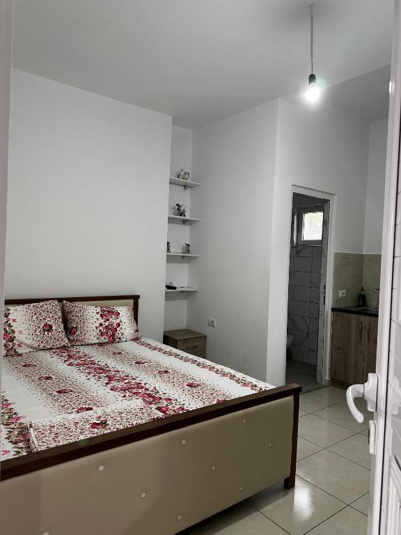 a bedroom with a bed in a white room at Grandma's in Sarandë