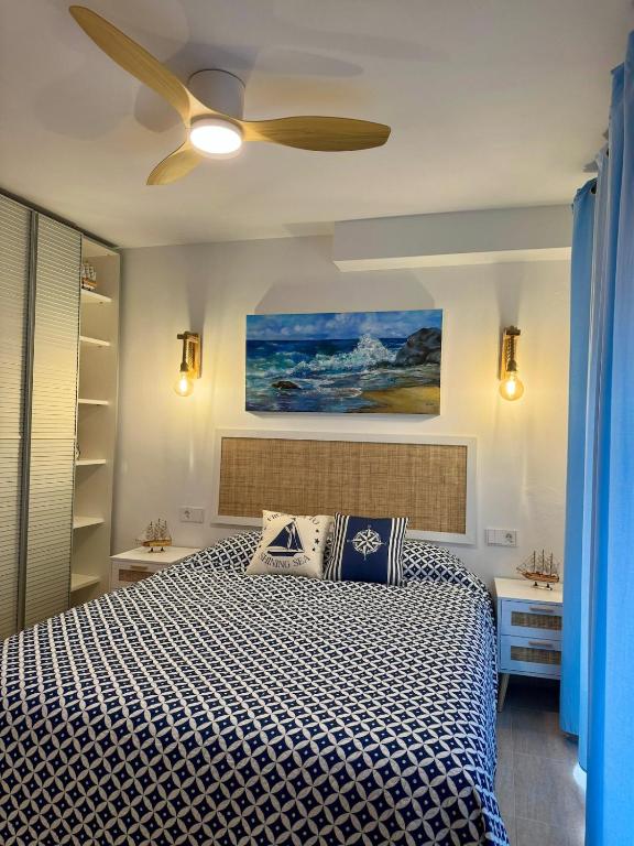 a bedroom with a bed with a ceiling fan at Petit Paradís in Sant Antoni de Calonge