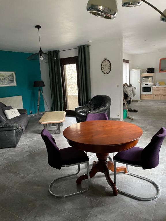 un salon avec une table et des chaises en bois dans l'établissement Maison de village avec extérieur, à Anse