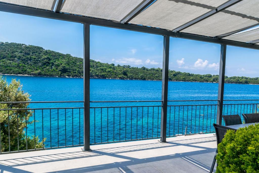 a view of the water from the balcony of a house at House Paval in Brnistrova