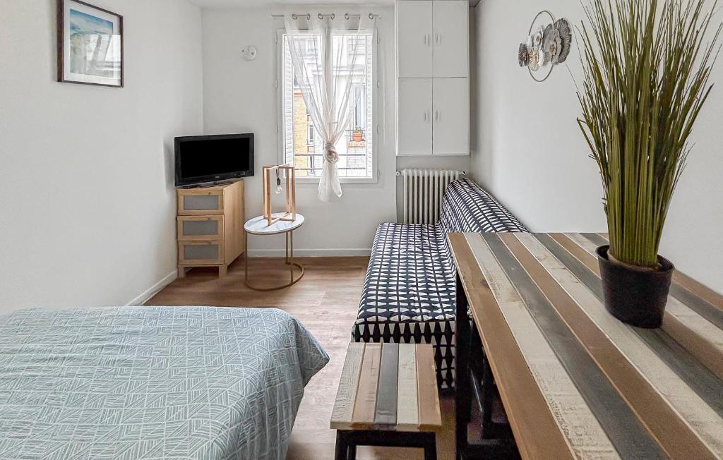Μια τηλεόραση ή/και κέντρο ψυχαγωγίας στο Studio cosy rénové, proche métro & Stade de France