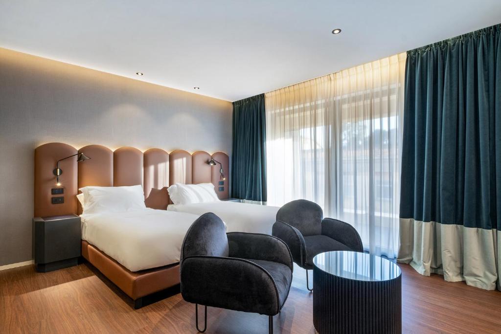 Postel nebo postele na pokoji v ubytování Eurostars Matera La Suite