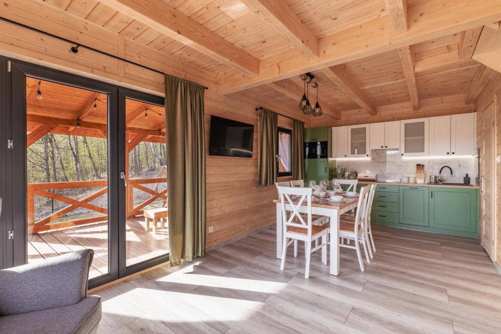 a kitchen and dining room with a table and chairs at Harmonia Lasu in Solina