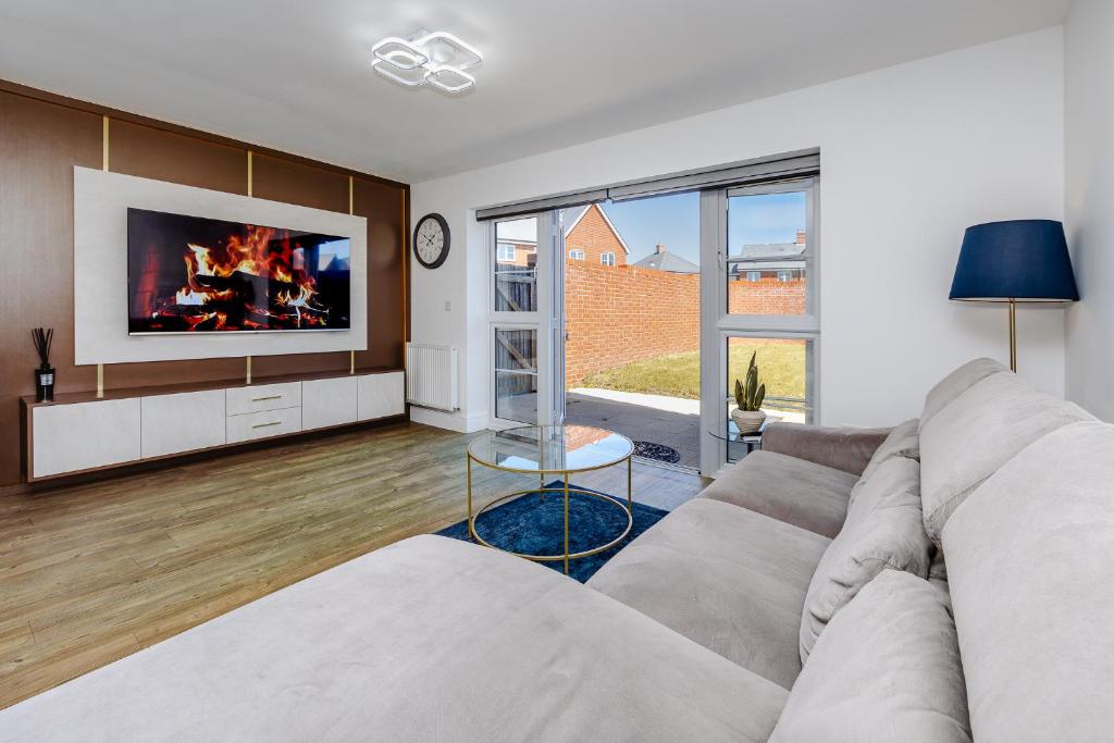 a living room with a couch and a tv at My Chester Luxury Home in Colchester