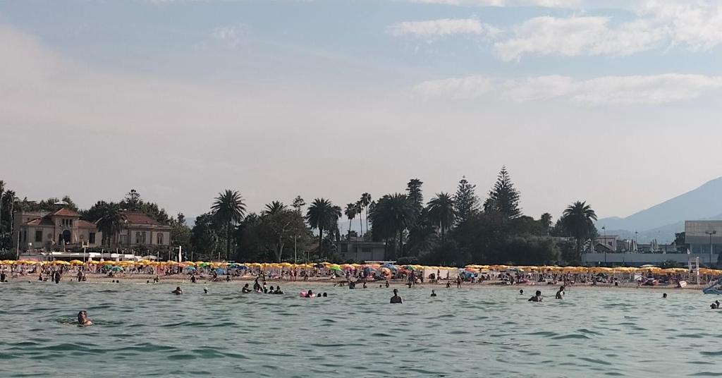 a group of people in the water at a beach at House in Garden in Palermo
