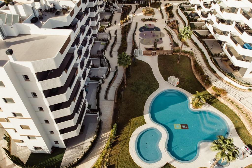 an aerial view of a large apartment complex with a swimming pool at Sea Arenales del Sol in Arenales del Sol