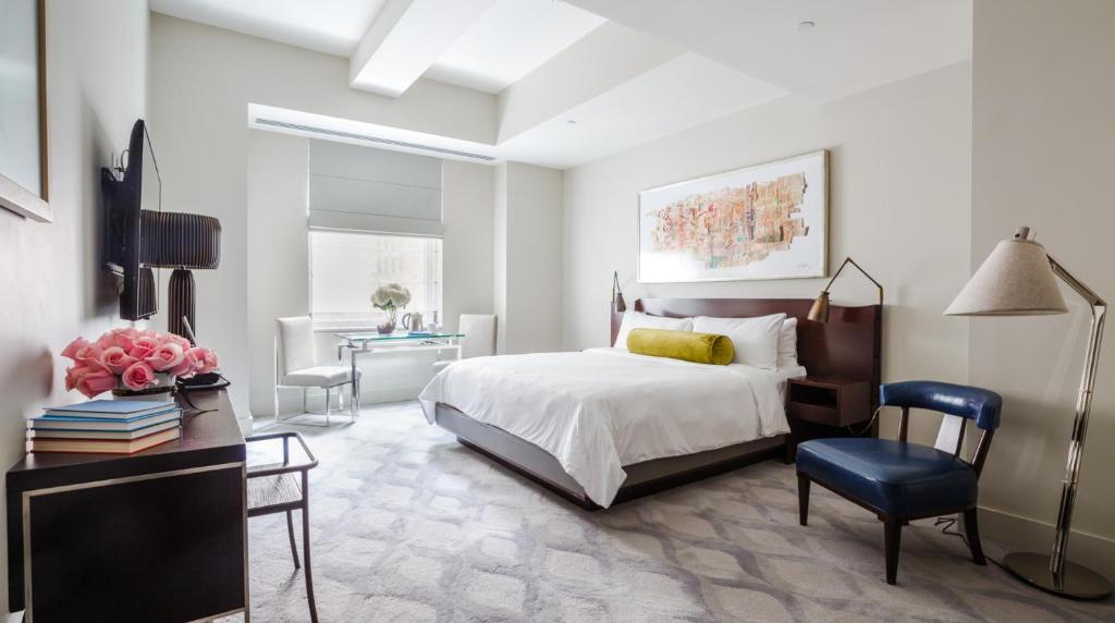 a bedroom with a bed and a desk and a chair at The Marmara Park Avenue in New York