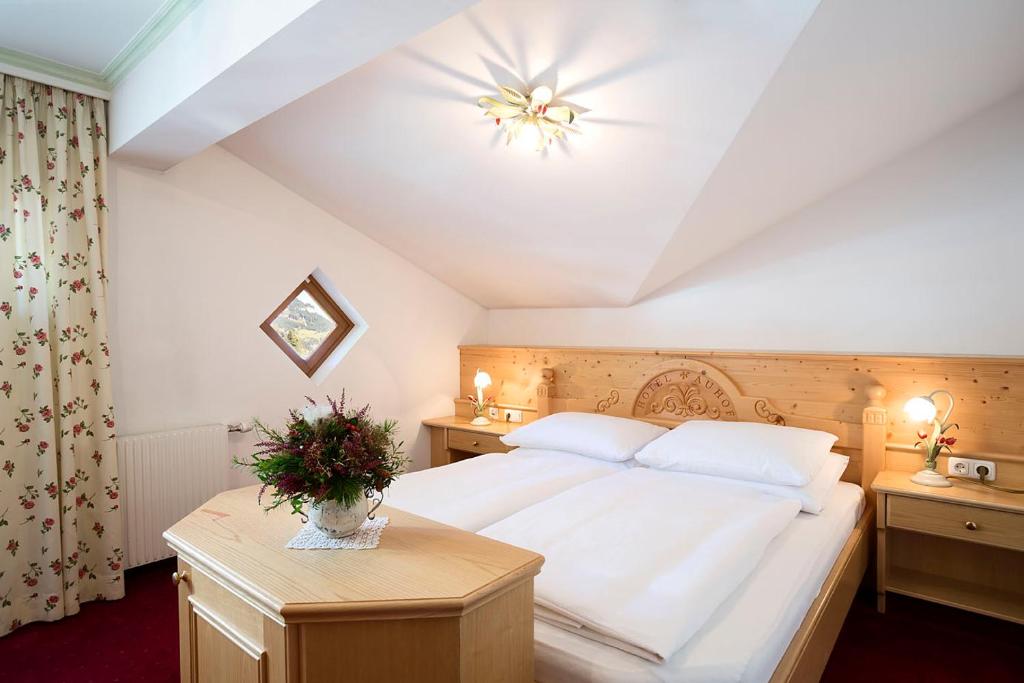 A bed or beds in a room at Hotel Auhof