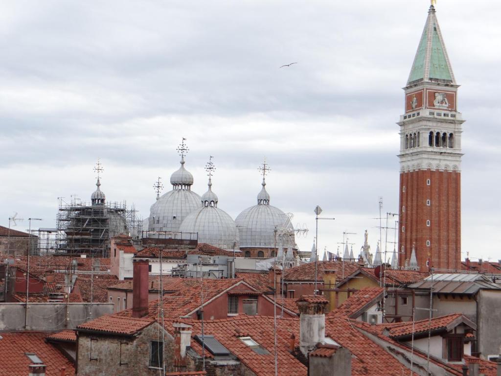 a view of a city with a clock tower and roofs at appartamento Casanova in Venice