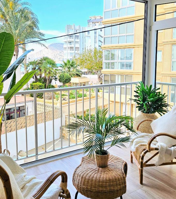 a balcony with chairs and plants and a view of a city at Boho Arenal Bol in Calpe
