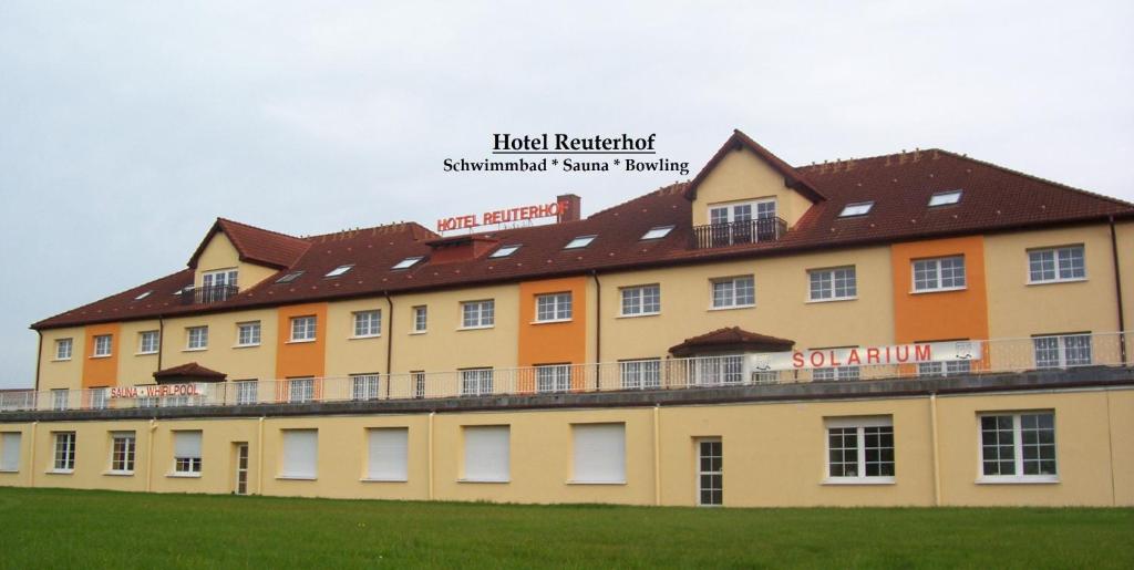 a large yellow building with a brown roof at Hotel Reuterhof in Reuterstadt Stavenhagen