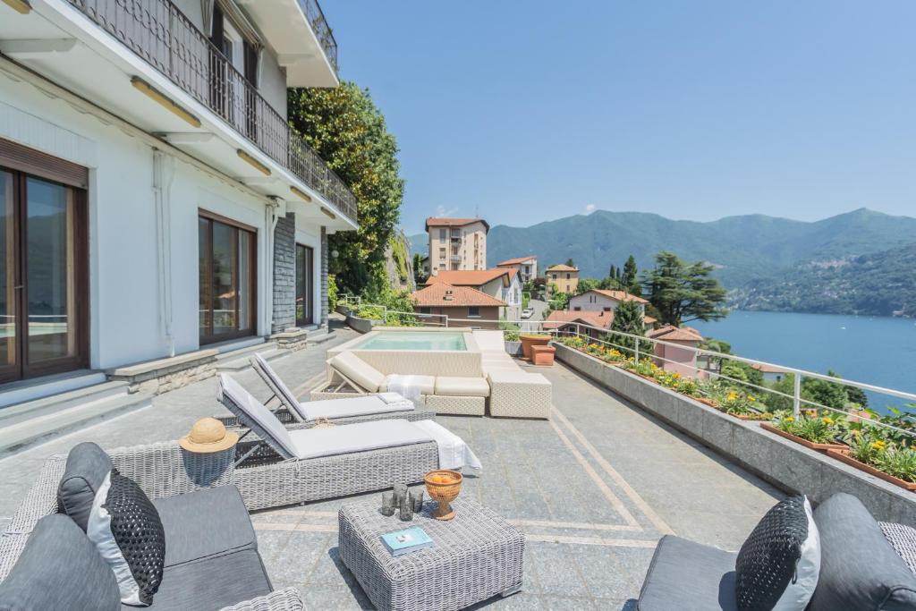 a house with a balcony with a view of the water at Villa Chiara Lake Como with private garden in Moltrasio