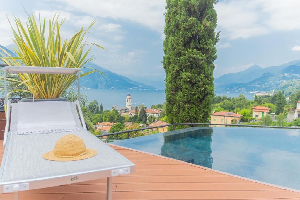 a hat sitting on a bench next to a swimming pool at Villa Cosima in Bellagio with Private Pool in Bellagio