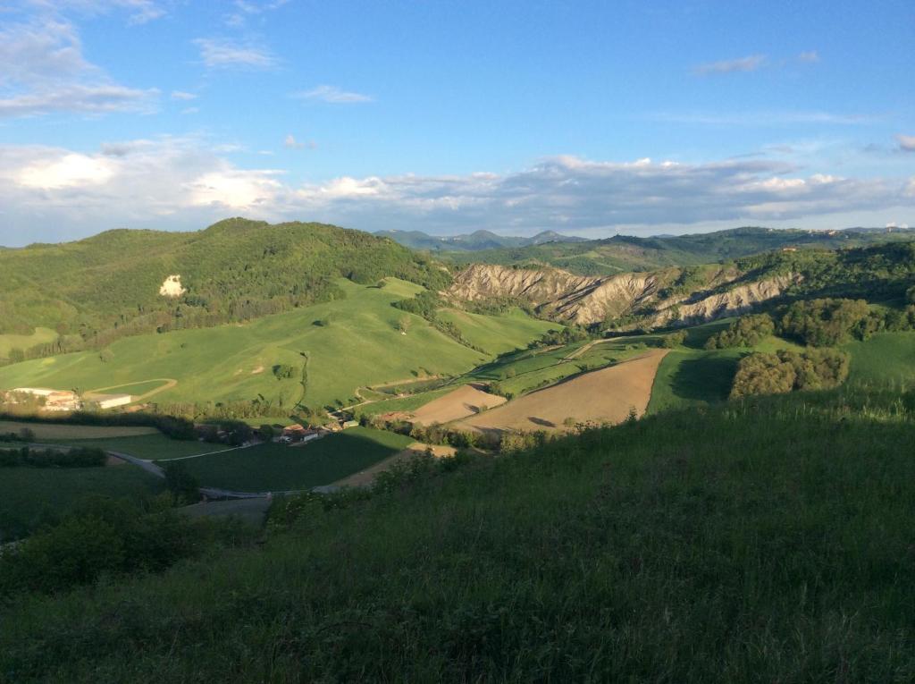 a view of a golf course in the mountains at B&B Villa Rossana in Langhirano