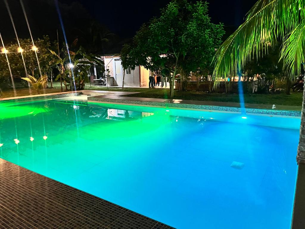 a swimming pool at night with blue lights at Casa in Ahuashiyacu