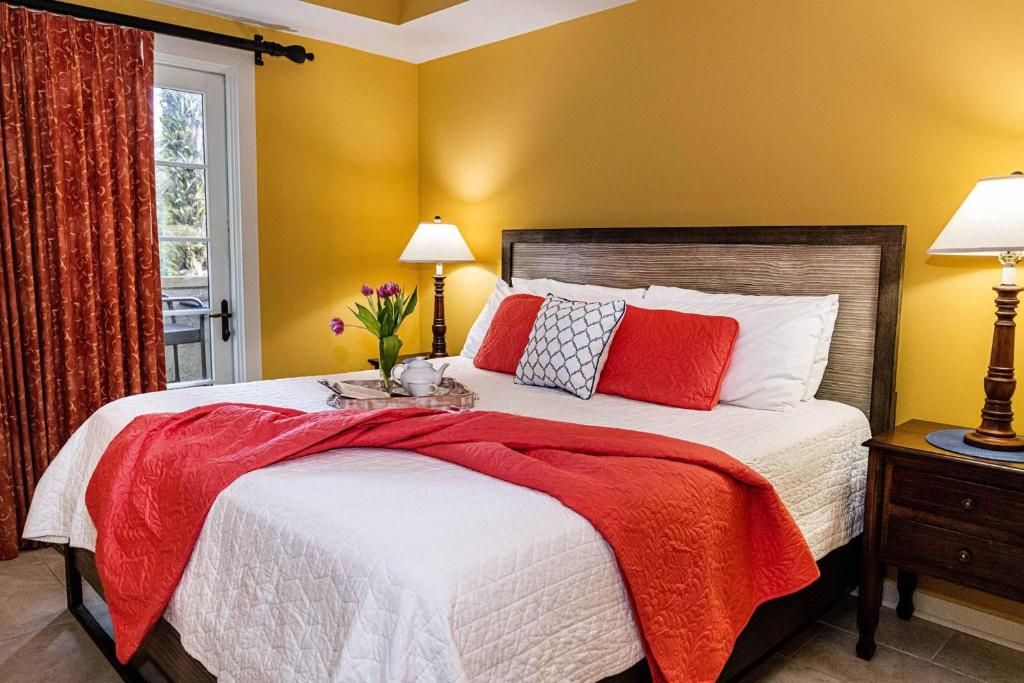 a bedroom with a large bed with red pillows at Luxurious-amazing Pool View from balcony 5216LP in Saint Augustine