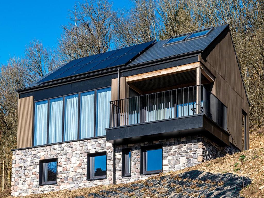 a house with solar panels on top of a hill at Villa in Belgium with Private Terrace in La Roche-en-Ardenne