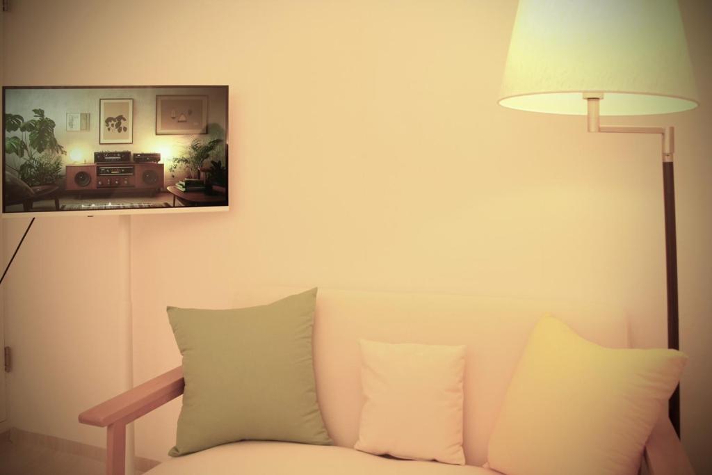 a living room with a couch and a lamp at Samseong COEX Jamsil Lotte Tower NStay in Seoul