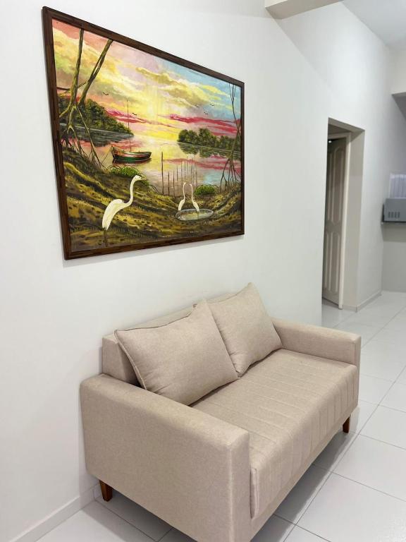 a couch in a room with a painting on the wall at ORLA FLAT - Apartamento 02 in Bragança