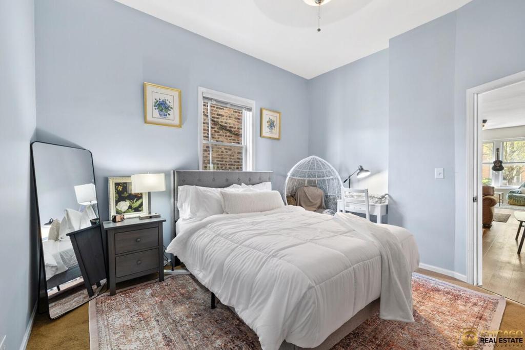 a bedroom with a large white bed and a mirror at Prime Location Retreat 4 Bedrooms w Parking in Chicago