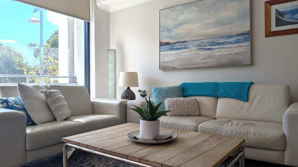 a living room with a couch and a coffee table at Beachfront Nautilus in Rockingham